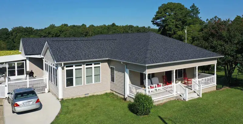 Drone view of a Triangle home with a new Chief Roofing roof and clean gutter lines